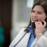 Doctor in white coat on phone
