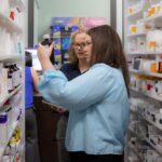 Pharmacists reviewing prescription bottles