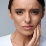 Woman experiencing toothache discomfort