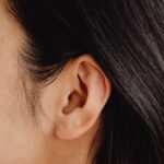 Profile of ear and straight hair.