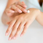 Moisturizing hands with cream