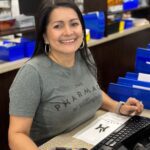 Smiling woman at pharmacy counter