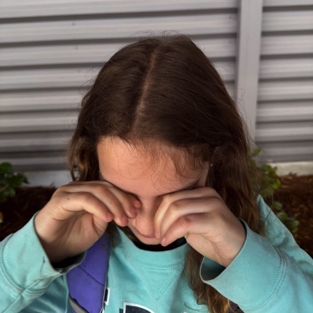 Girl rubbing eyes