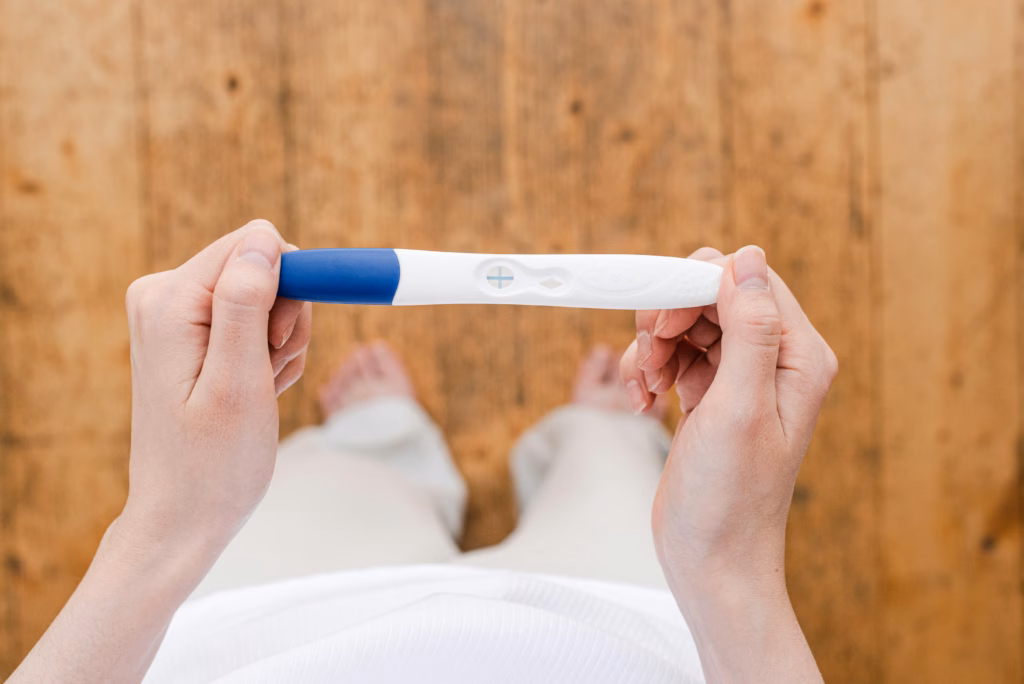 Woman checking a pregnancy test for results