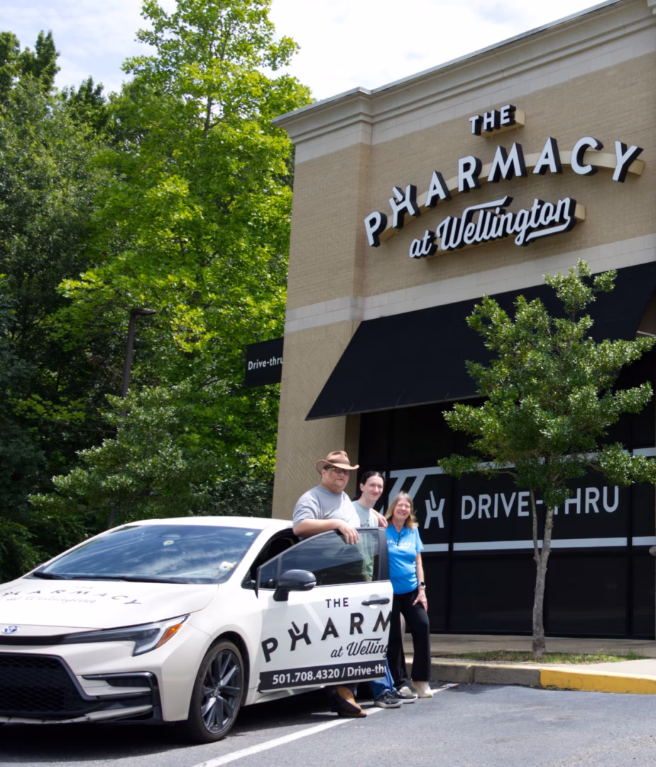 Three drivers in front of the pharmacy.
