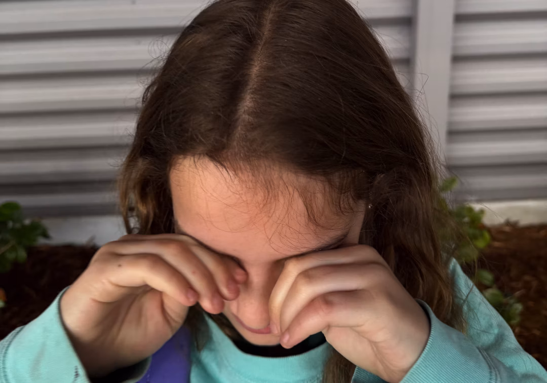 Girl rubbing eyes
