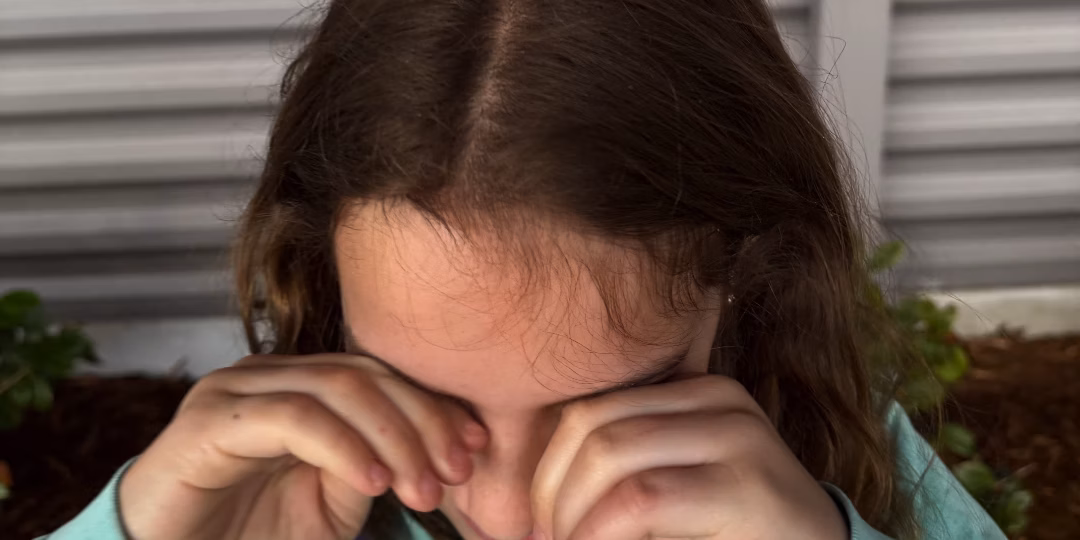 Girl rubbing eyes