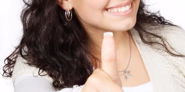 smiling female showing a thumbs up