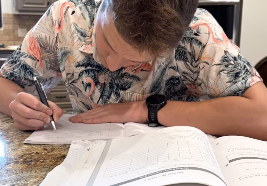 Student taking notes by hand